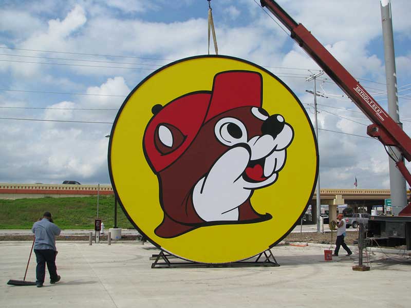Photo of Buc-ee's sign being lifted by crane